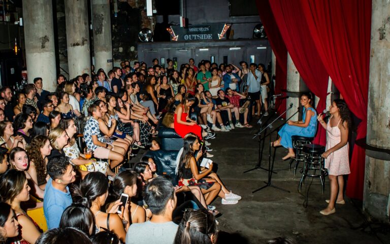 Woman with microphone standing in front of audience